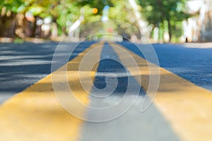 Abstract blurred background road leading through an autumn city surrounded by trees