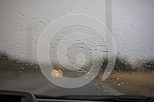 Abstract blurred background of water jet on misted car windshield, horizontal