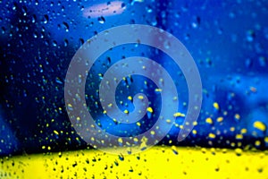 Abstract blurred blue and yellow background with drops