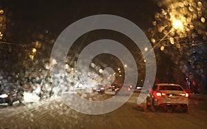 Abstract blurred city background. The view from the car window on the night city. Blurry bokeh lights, street lights