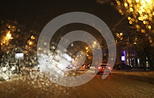 Abstract blurred city background. The view from the car window on the night city. Blurry bokeh lights, street lights