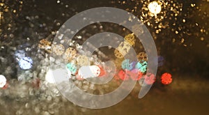 Abstract blurred city background. The view from the car window on the night city. Blurry bokeh lights, street lights and car