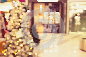 Abstract blurred and defocused background of shopping mall with bokeh. Christmas lights and garlands