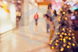 Abstract blurred and defocused background of shopping mall with bokeh. Christmas lights and garlands