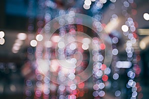 Abstract blurred and defocused background of shopping mall with bokeh. Christmas lights and garlands