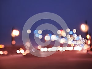 Abstract blurred defocused night city background with traffic lights bokeh