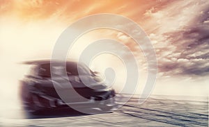 Abstract blurred drift car with smoke from burned tire at sunset