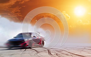 Abstract blurred drift car with smoke from burned tire at sunset