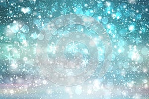 Abstract blurred festive winter christmas or Happy New Year background with shiny blue and white bokeh lighted snow landscape with