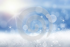 Abstract blurred festive winter christmas or Happy New Year background with shiny blue and white bokeh lighted snow landscape with