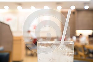 abstract blurred Glass of water in restaurant with bokeh background