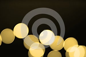 Abstract blurred gold bokeh lights background. Defocused glitter light