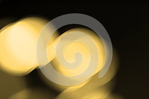 Abstract blurred gold bokeh lights background. Defocused glitter light