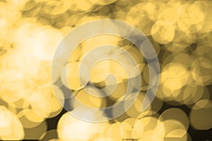 Abstract blurred gold bokeh lights background. Defocused glitter light