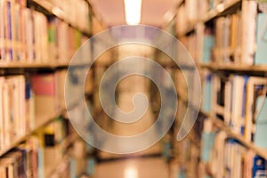 Abstract blurred image of books on bookshelf in school library. education learning or back to school concept background.