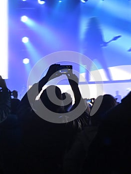 Abstract blurred image. Crowd during a entertainment public concert a musical performance. Hand fans in fun zone people