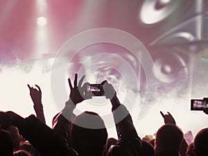 Abstract blurred image. Crowd during a entertainment public concert a musical performance. Hand fans in fun zone people