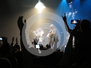 Abstract blurred image. Crowd during a entertainment public concert a musical performance. Hand fans in fun zone people