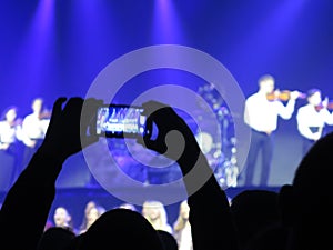 Abstract blurred image. Crowd during a entertainment public concert a musical performance. Hand fans in fun zone people