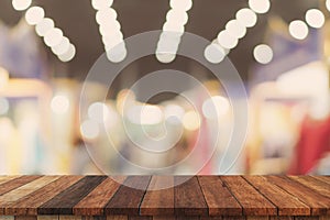 Abstract blurred image of department store with wooden table counter background for show , promote ,design on display concept