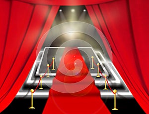 Abstract blurred image. Red carpet with stairs between two rope barriers and flash light. Scene illuminated by a spotlight.