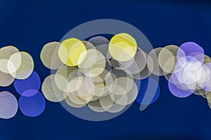 Abstract blurred lights on background in blue and yellow- christmas celebration concept
