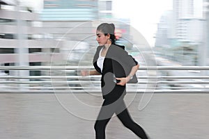 Abstract blurred motion of young Asian business woma running to work.