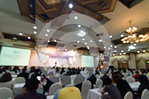 Abstract blurred photo background of business people in conference hall or seminar room. Defocused people in meeting room concept