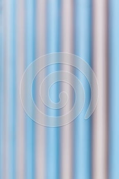 Abstract blurred photo of blue and grey corrugated metal wall ba