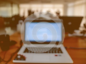 Abstract blurred Photo of Laptop in the office