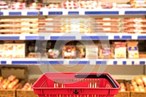 Abstract blurred photo of store with basket in department store bokeh background. business concept.