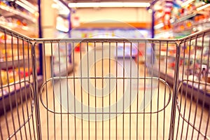 Abstract blurred photo of store with food trolley at a supermarket