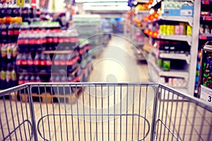 Abstract blurred photo of store with food trolley at a supermarket