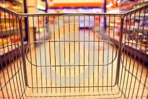 Abstract blurred photo of store with food trolley at a supermarket