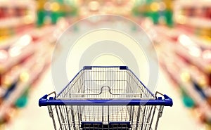 Abstract blurred photo of supermarket with empty shopping cart photo