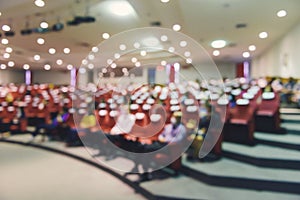 Abstract blurred put spaces between attendee in conference hall for social distancing to prevent the spread of Covid-19