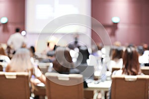 Abstract blurry background of employees seminar and De-focus teamwork staffs working meeting in conference room with projector