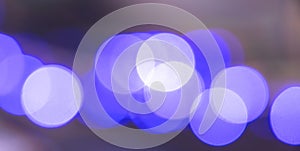 Abstract blurry blue bokeh light circles glowing in the night background