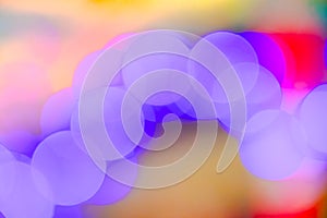Abstract blurry purple soft bokeh light circles glowing on colorful background