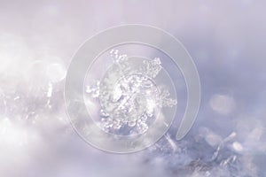 Abstract, blurry, winter background with macro snowflake