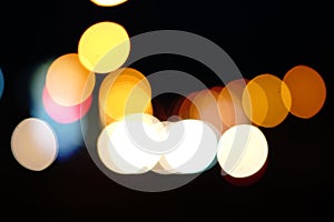 Abstract bokeh background, circles of light on dark background
