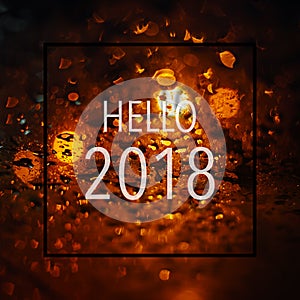 Abstract bokeh light background with text hello 2018