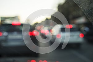 Abstract bokeh of light, blurred defocused lights of cars in traffic jam on a wet rainy road backgrounds