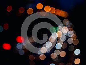 Abstract bokeh night light  background, blurred lights traces from cars on road, defocused city traffic on street at night