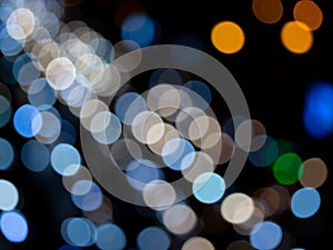 Abstract bokeh night light background, blurred lights traces from cars on road, defocused city traffic on street at night