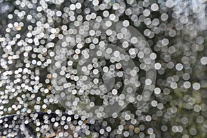 Abstract bokeh from raindrops on glass after rain