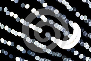 Abstract bokeh of white city lights on black background. defocused and blurred with moon of lights