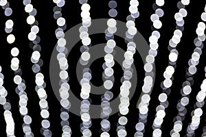 Abstract bokeh of white lights on black background. defocused and blurred many round light