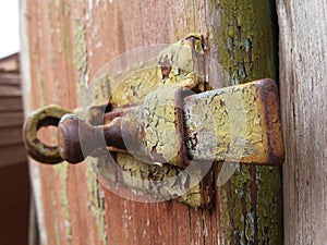 Abstract with the bolt and rustes on it on the wooden door.