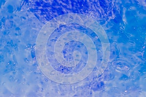 Abstract bright blue background made of transparent slime with air bubbles
